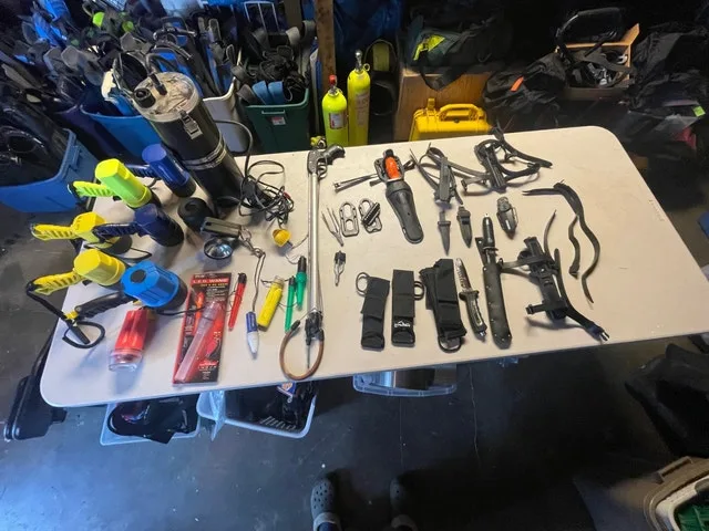 Scuba diving lights, cutting devices and flags with floats