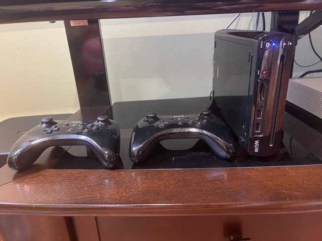 Wii U with two pro controllers and games