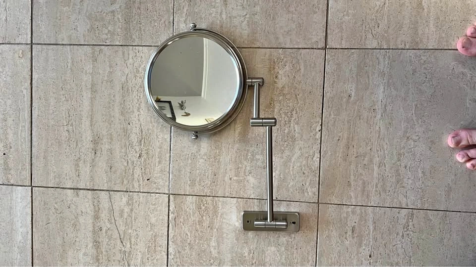 Magnifying wall mirror