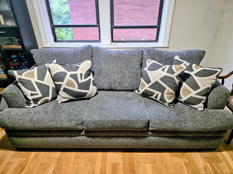 Gray Three-Cushion Sofa with Four Patterned Pillows