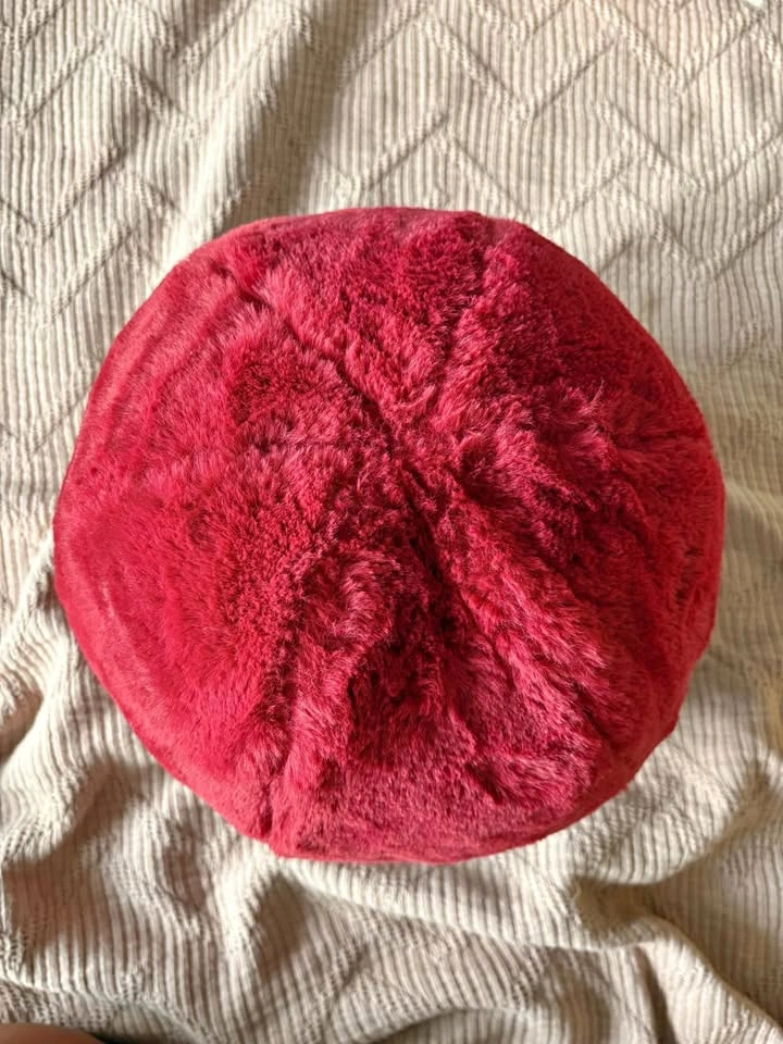 Fluffy round red cushion