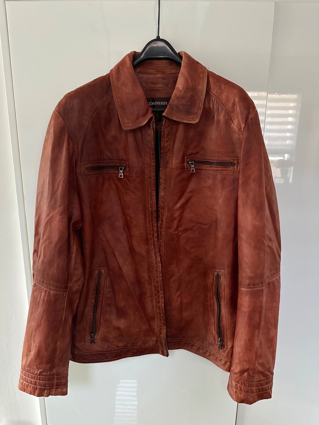 Danier men's distressed leather jacket in a cognac brown hue.
