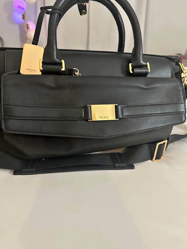 Black and gold leather TUMI weekender duffel bag