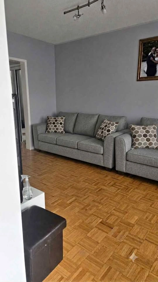 A pair of Grey Fabric Three-Seater Sofas