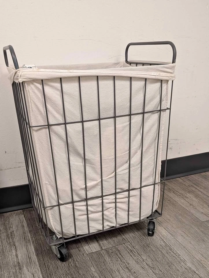 Metal laundry basket on wheels with liner