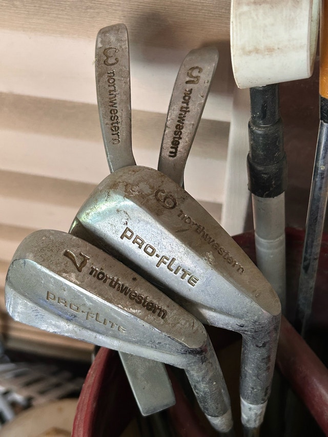 Vintage golf clubs and balls
