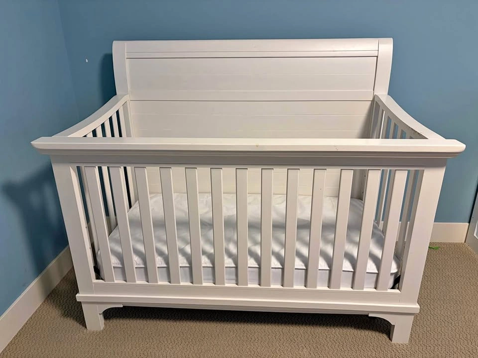 Wooden baby crib with mattress