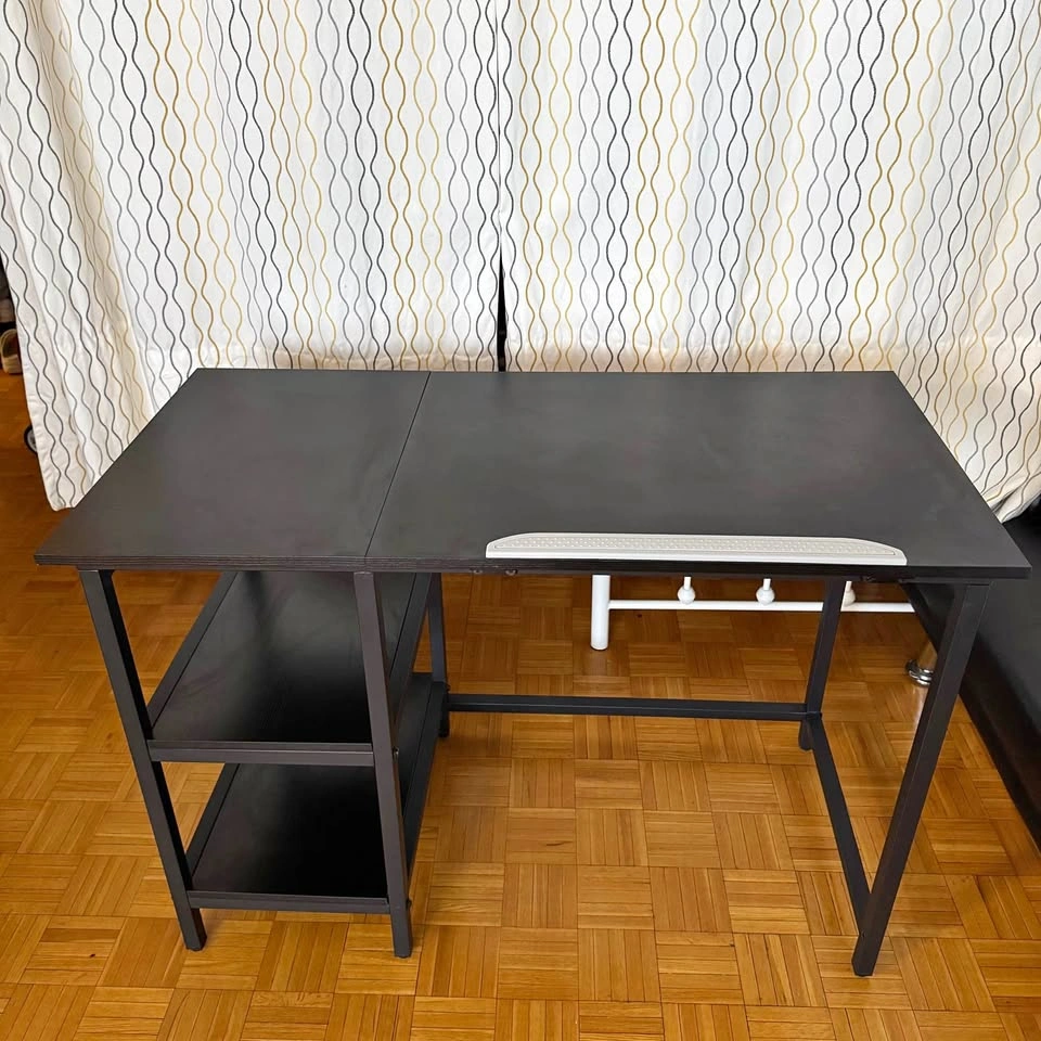 Black desk with tilting tabletop