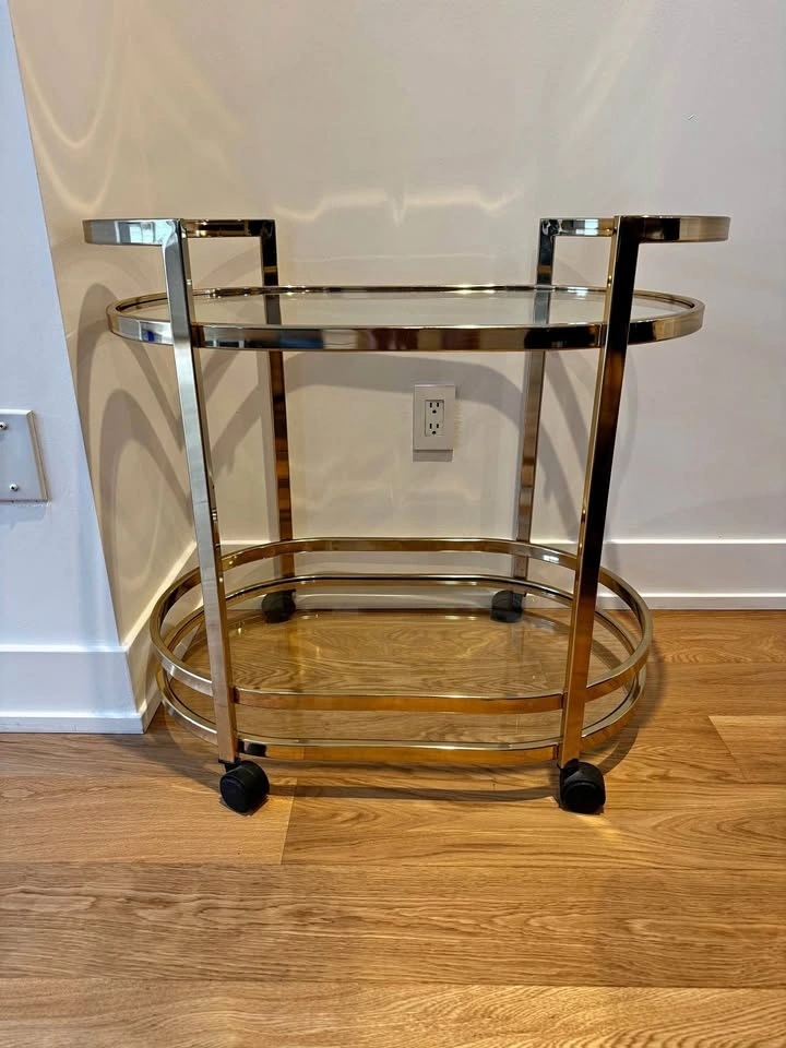 Gold bar cart with glass shelves and castors