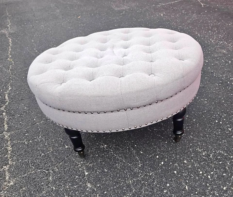 Grey tufted fabric ottoman
