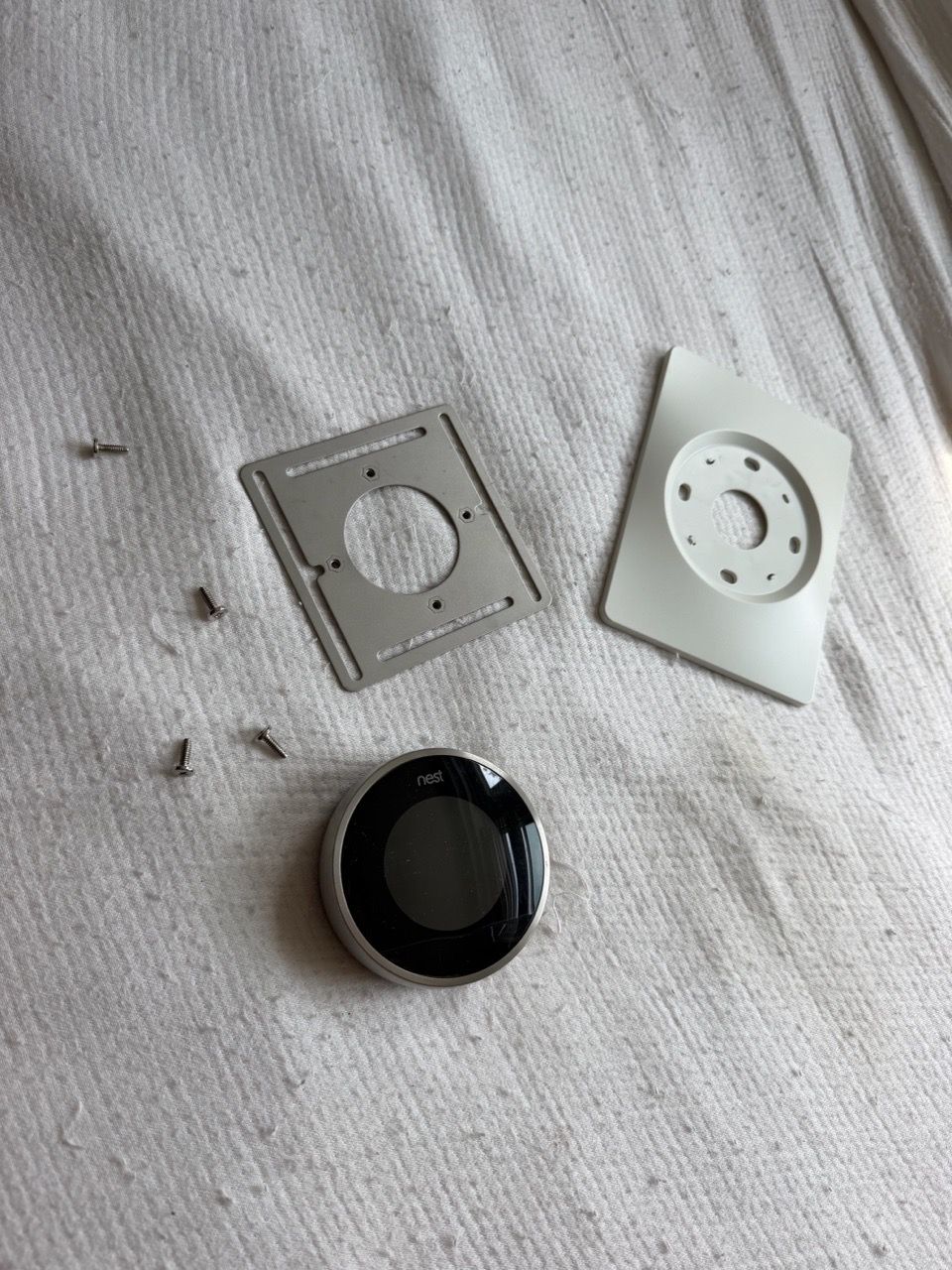 Google Nest 2nd gen smart thermostat with mounting hardware