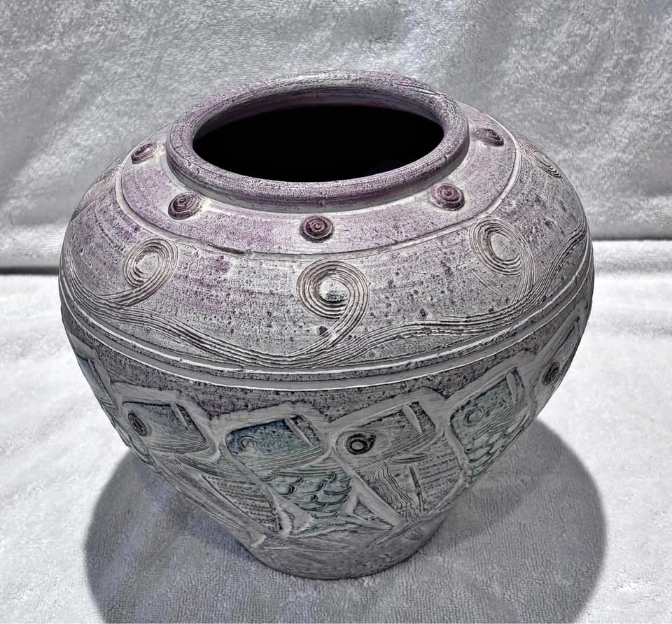 Pottery vase with embossed fish motif and green accents