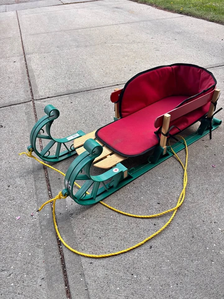 Green sled with red padded seat