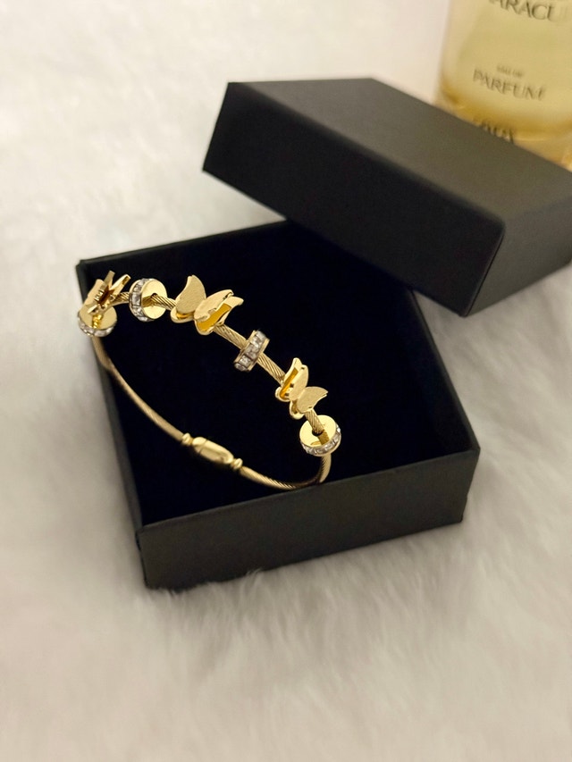 Gold tone butterfly cable bangle bracelet