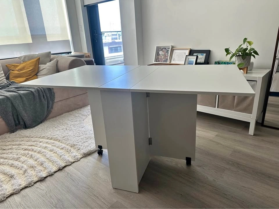 White expandable folding dining table with built-in storage