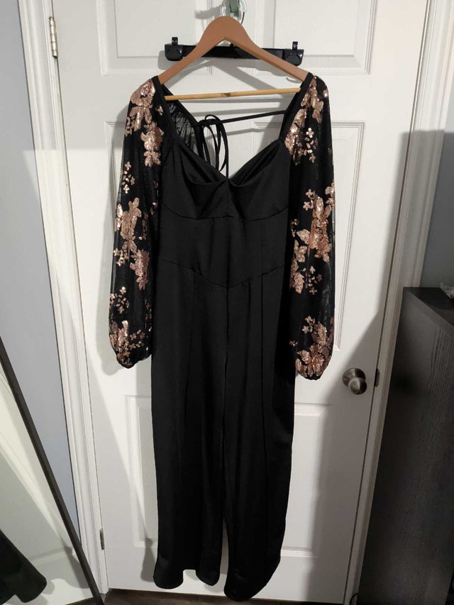 Brand new black jumpsuit with gold sleeves