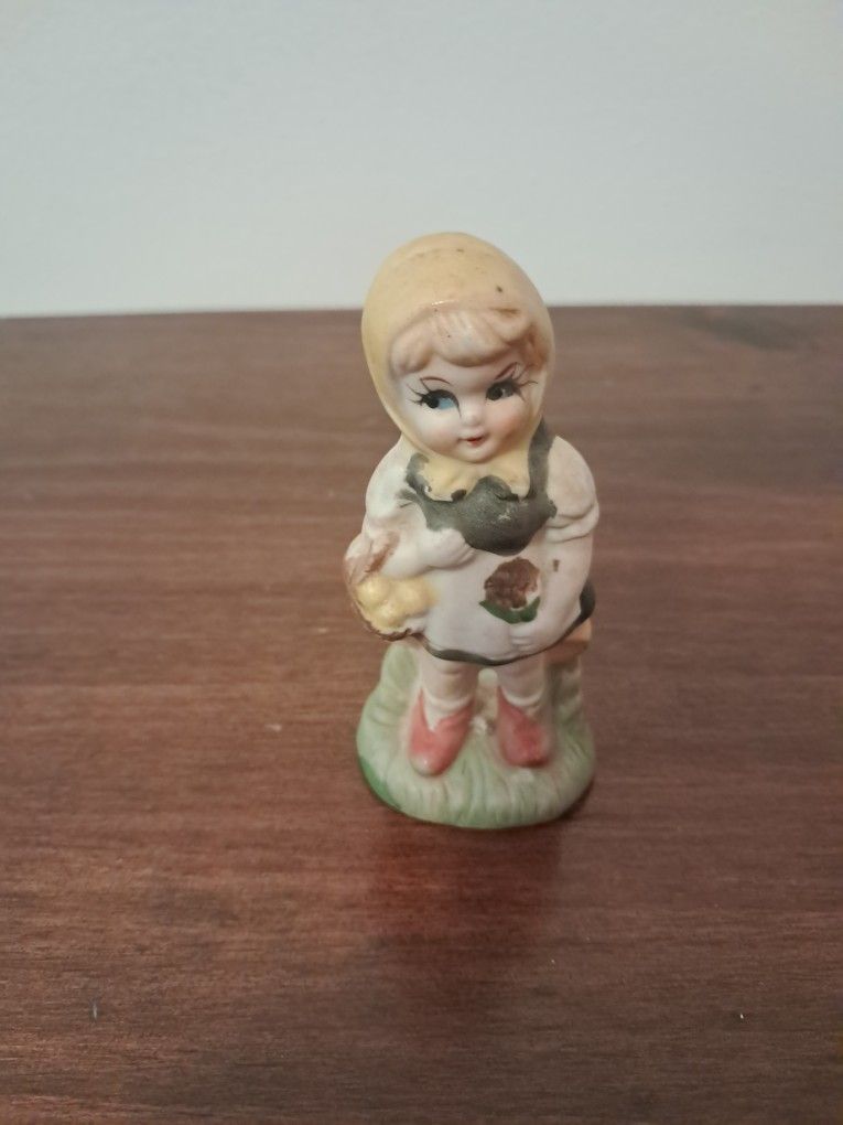 Vintage figuring little girl holding a basket mid twentieth cent