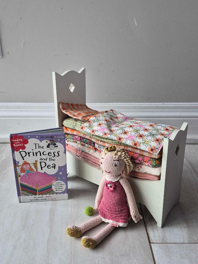 Princess and the pea doll, wooden bed, and book set