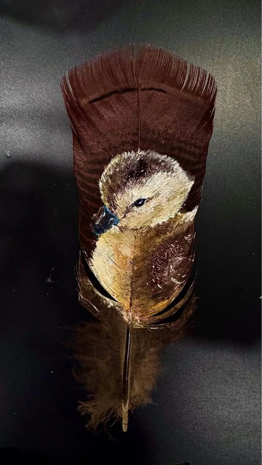 Duckling painted on a turkey vulture feather