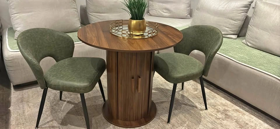 Round Wooden Dining Table with Storage Base and 2 Green Chairs