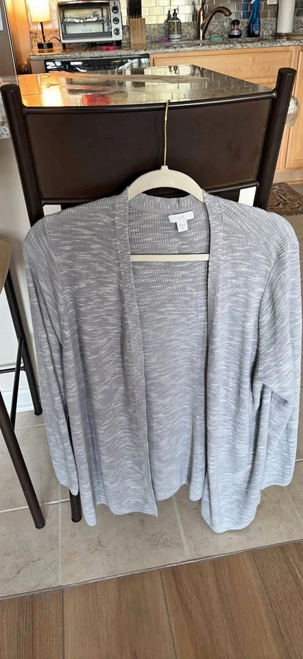 Adorable woman’s light grey cardigan sweater