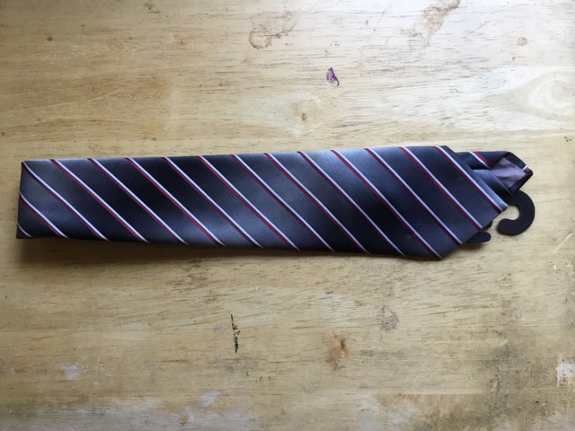 grey necktie with red and white stripes