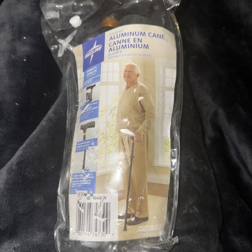 NEW ADJUSTABLE AND FOLDING METAL WALKING CANE. SUPPORTS WEIGHT U