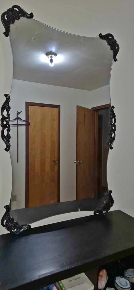 Frameless Wavy Mirror with Black Decorative Accents