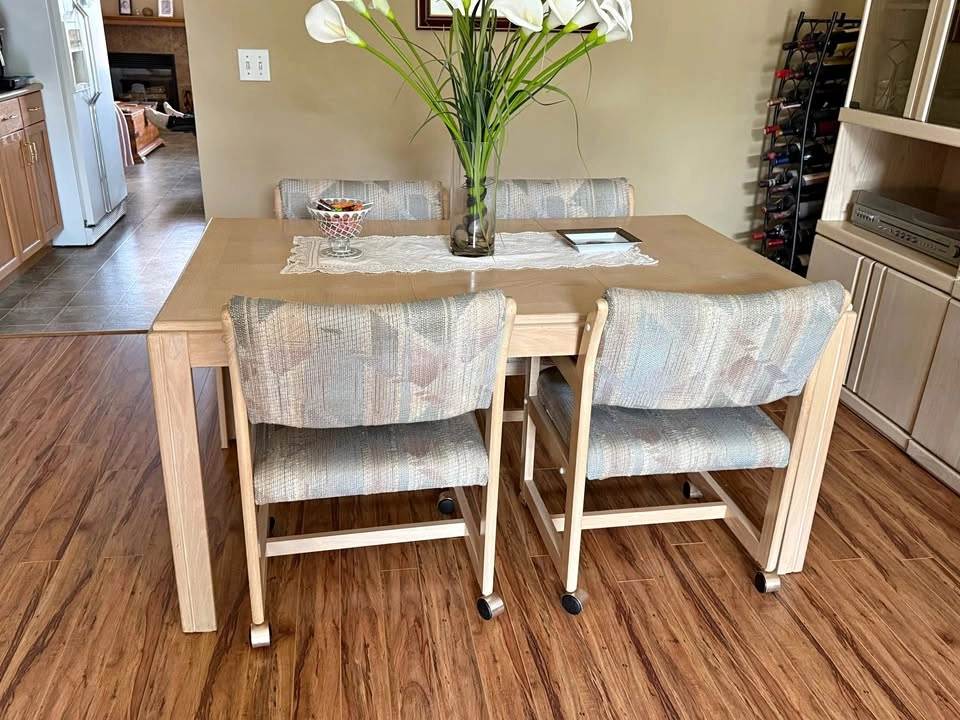 Light Wood Dining Table with 4 Caster Chairs and 3 display hutch