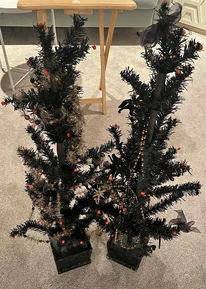 Pair of 3 ft black fake trees with some decor