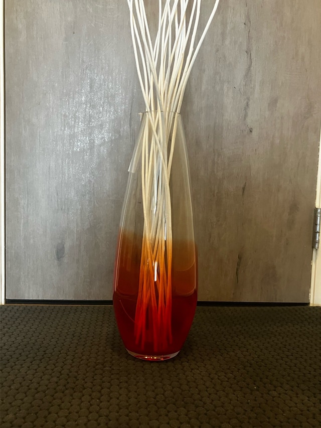 Glass vase with reeds