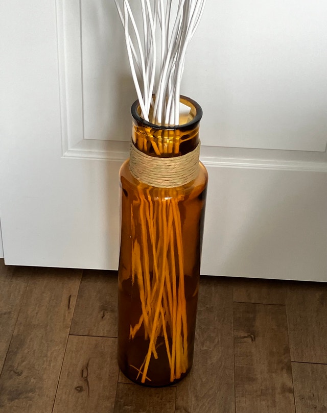 Glass vase with reeds