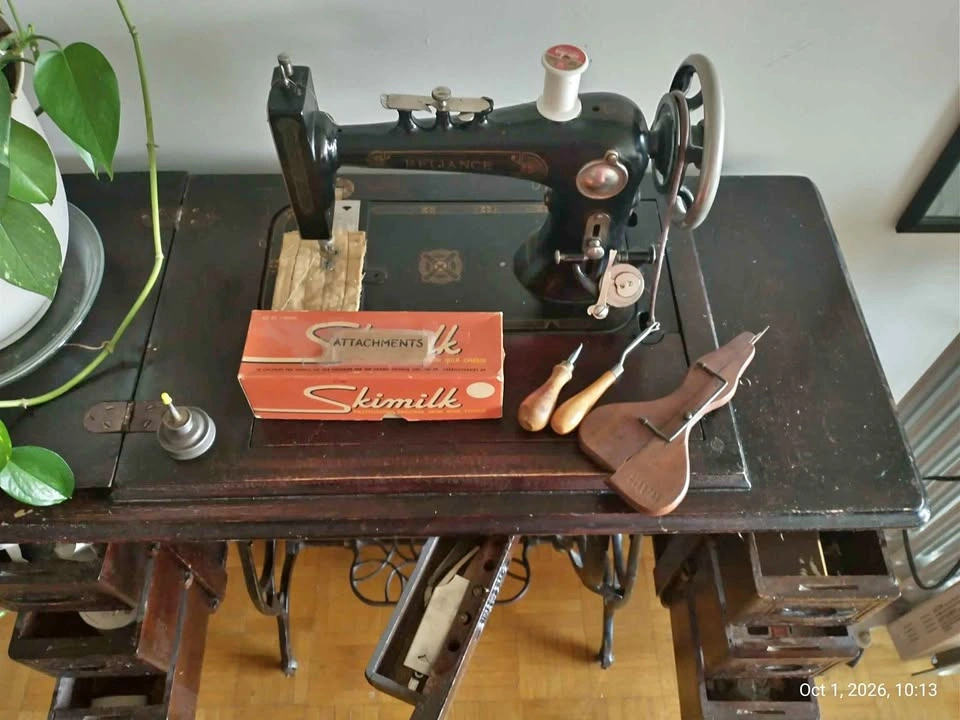Vintage Reliance sewing machine with parts and supplies