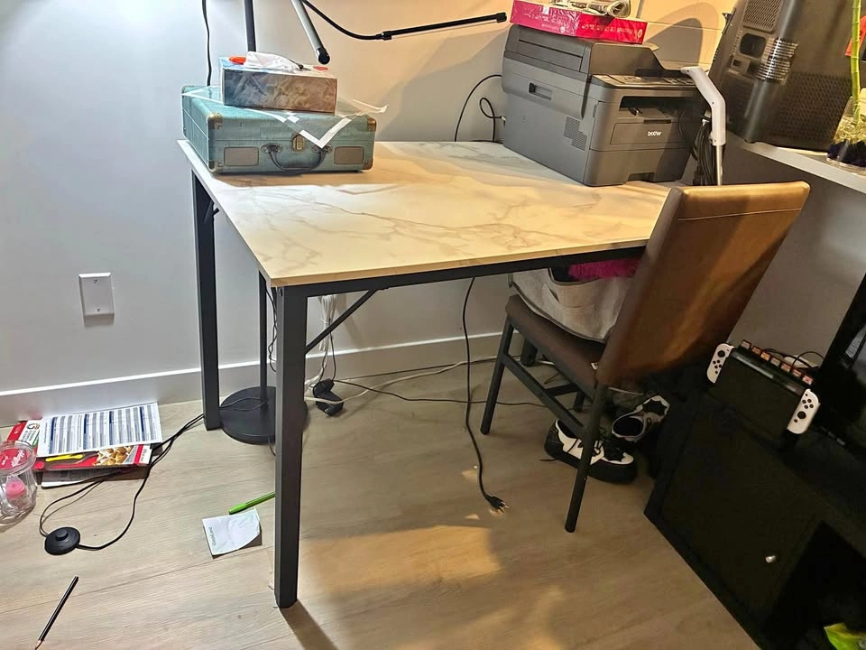 Faux marble table with brown faux leather chairs