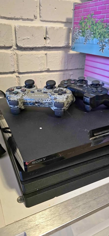 Sony PlayStation 3 Slim with 2 DualShock 3 Controllers
