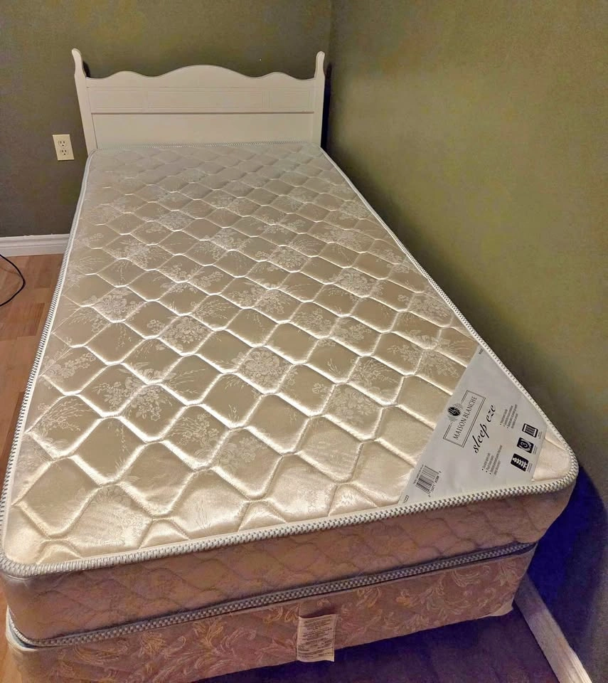 Twin mattress and box spring set on rolling frame
