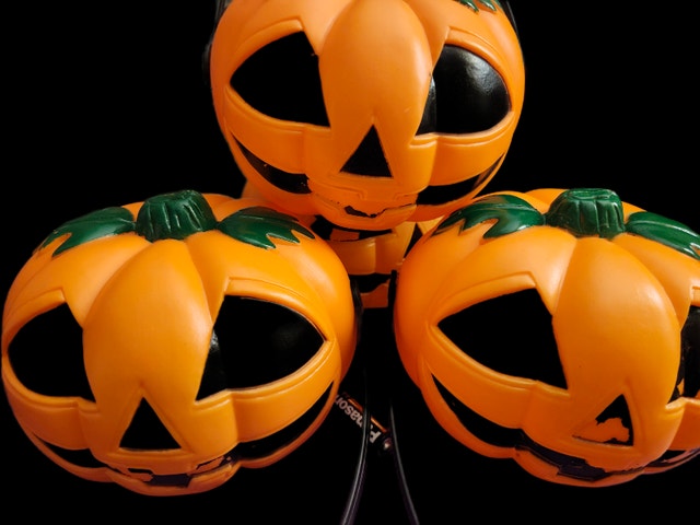 Three Light-Up Plastic Pumpkin Decorations