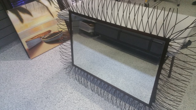 Wall mirror with beveled glass and metal frame