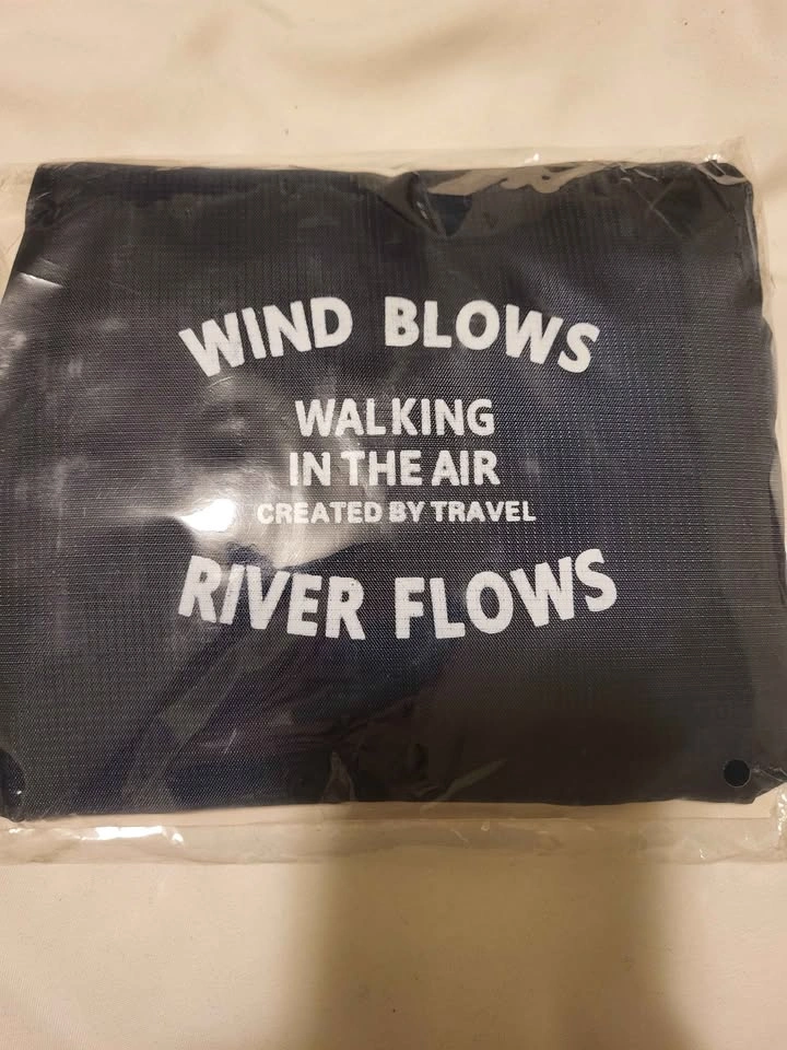 Travel bag. Attaches to handle of suitcase. Folds into a small s