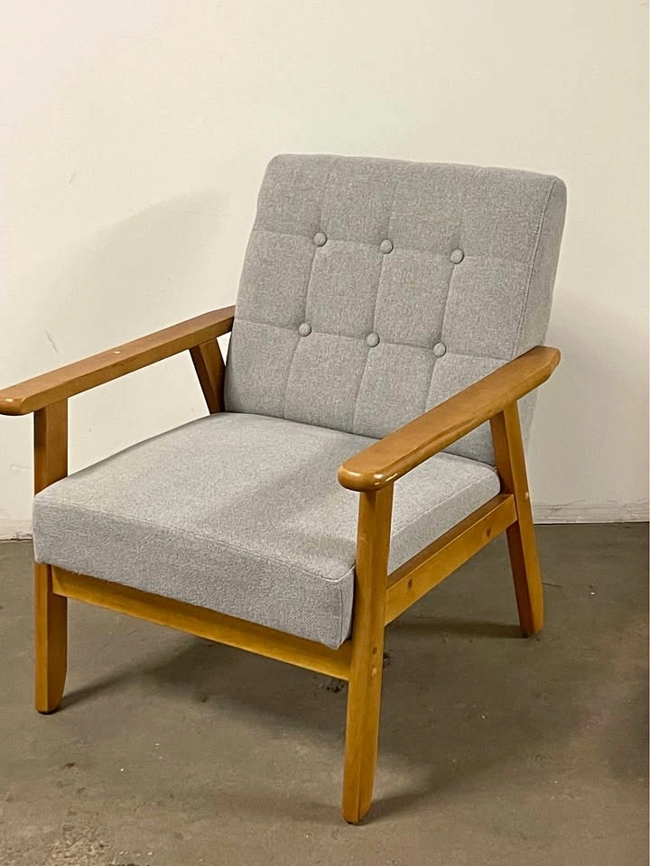 Armchair upholstered in light gray fabric