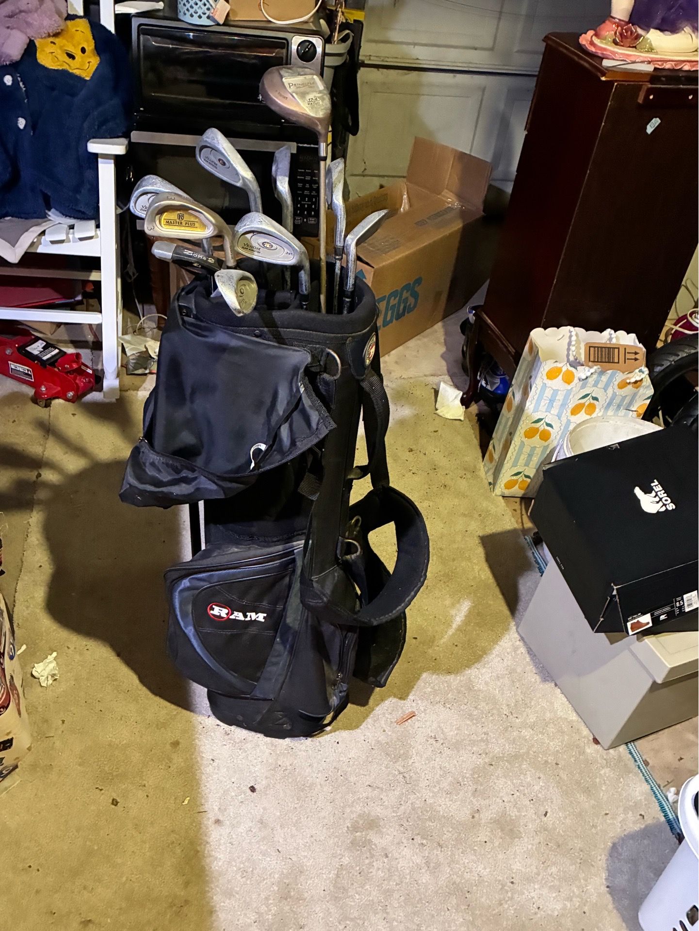 Ram standing golf bag with various golf clubs