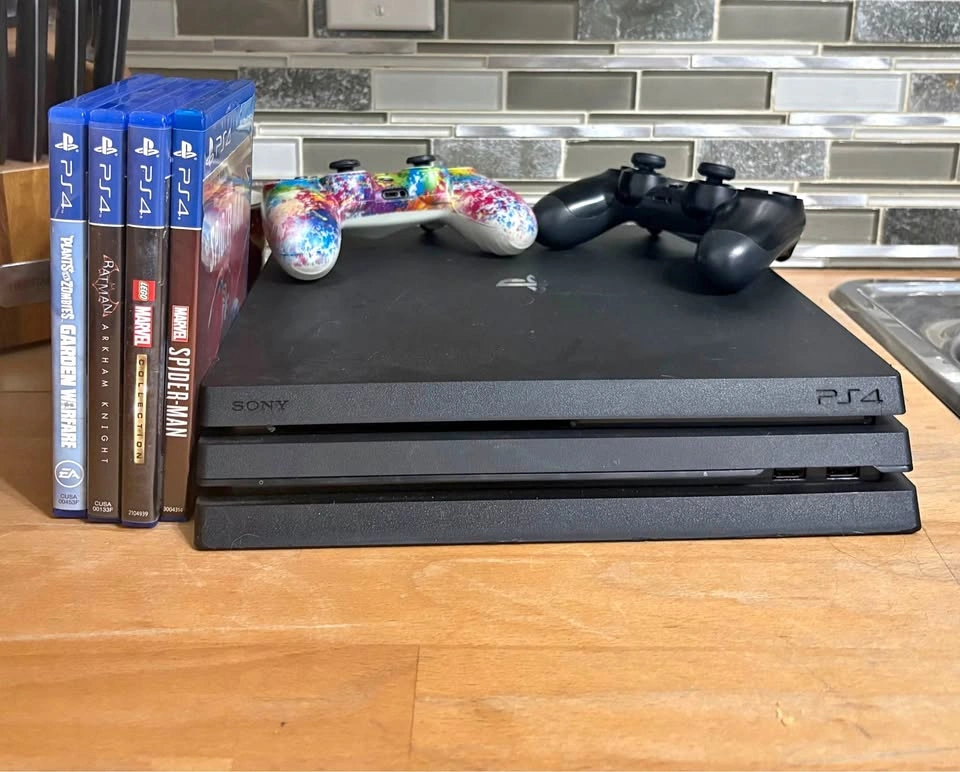 Sony PlayStation 4 Pro with 2 Controllers and 4 Games