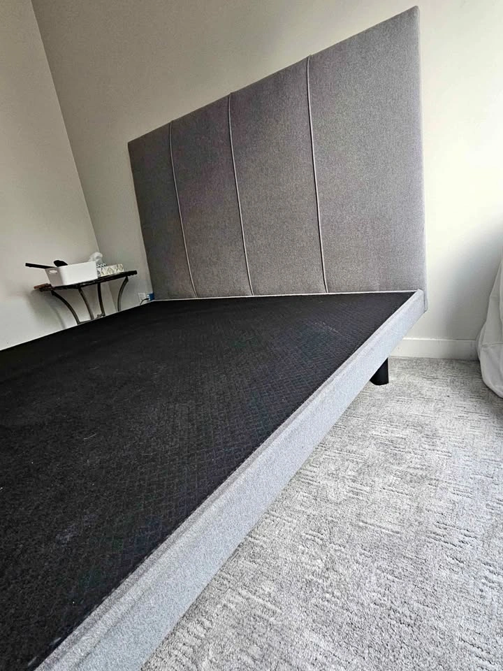 Solid bed frame with grey upholstered headboard