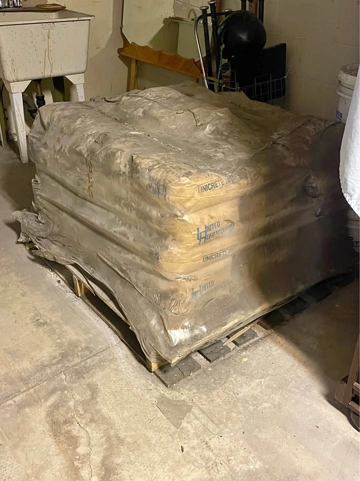 Skid of old set concrete bags