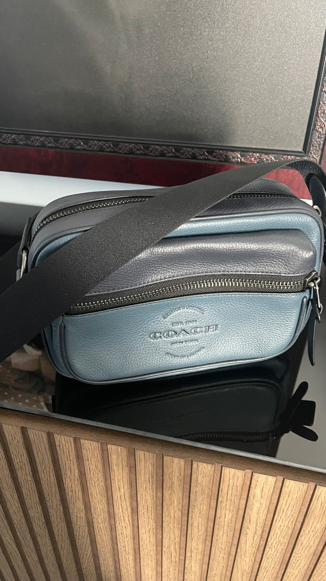 Coach Thompson mans camera bag