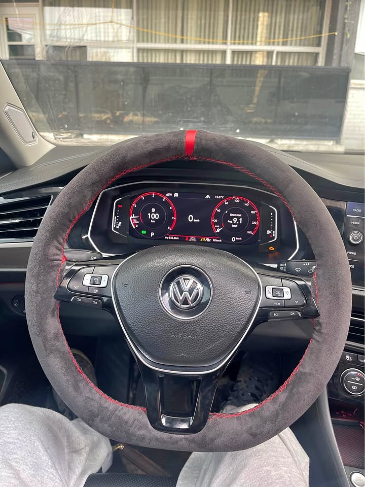 Alcantara steering wheel wrap hand stitching