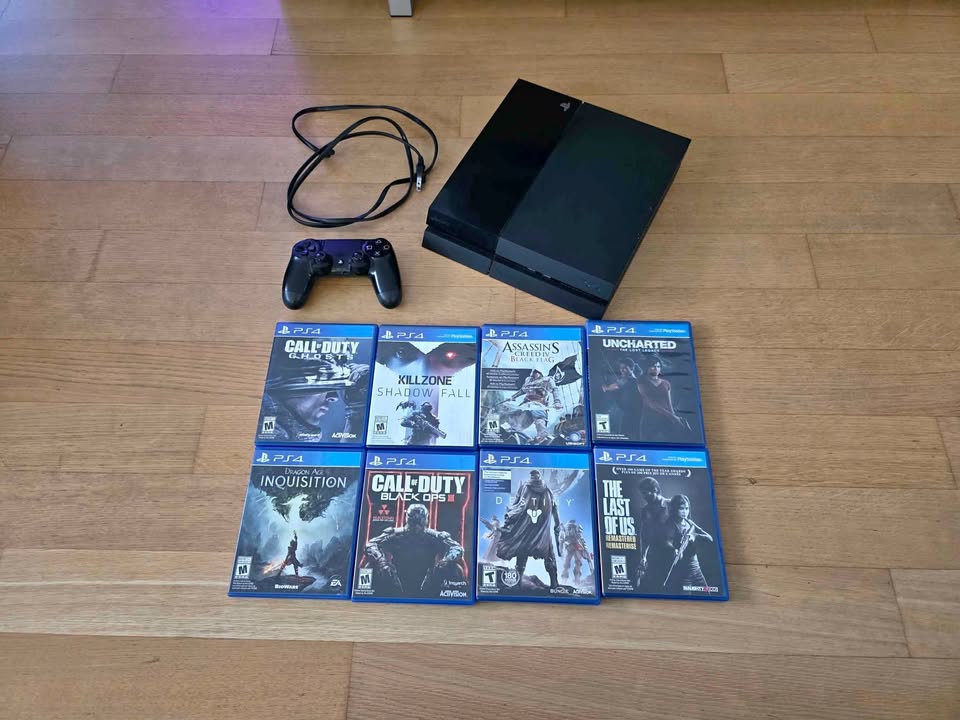 PS4 with one controller and 8 games