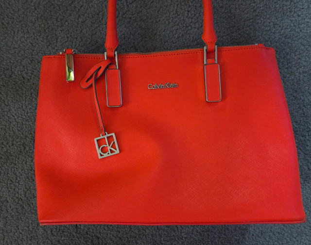 Authentic Calvin Klein Women Handbag. Orange. Slightly worn.