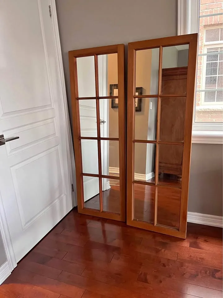 A pair of large wooden framed mirror