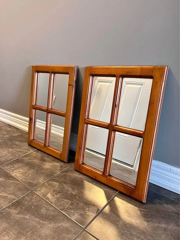 A pair of wooden framed mirror